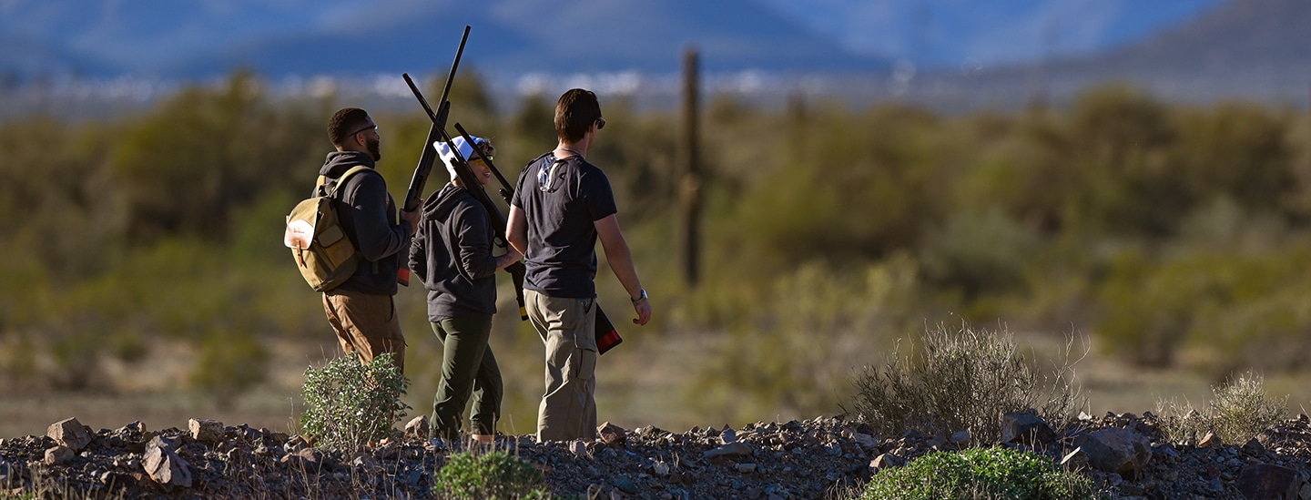 Shooters walking together through rocky terrain